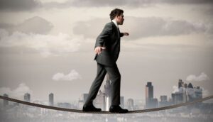 Businessman is balancing on a rope